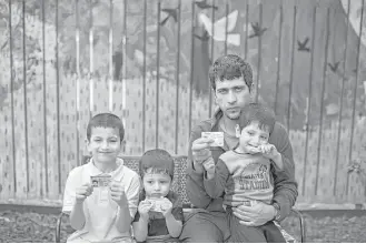  ?? Marie D. De Jesús / Houston Chronicle ?? As is the case for many Afghans, just one name identified former U.S. military translator Rezashah and his sons: from left, Murid, 7; Murab, 4; and Mujib, 3. The family has petitioned to legally adopt a surname in the United States. Dozens of new...