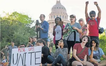  ?? JAY JANNER, AP ?? Protesters against the state’s Senate Bill 4 that bans sanctuary cities gather this month outside the Texas Department of Insurance building in Austin where Republican Gov. Greg Abbott has an office.