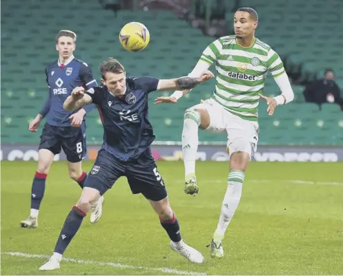  ??  ?? 0 Celtic’s Christophe­r Jullien, right, and Ross County’s Callum Morris battle for the ball during the Parkhead side’s midweek win.