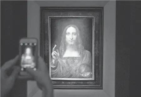  ??  ?? Leonardo da Vinci’s “Salvator Mundi” sold at auction for a record-breaking $450 million. DREW ANGERER/GETTY IMAGES