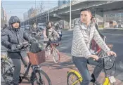  ??  ?? WHEEL IT: Commuters on a mix of personal and bike-share bicycles during morning rush hour.