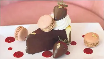  ?? SUGAR FACTORY ?? A decadent, dark chocolate-draped cheesecake with all kinds of accoutreme­nts is on the menu for mom at the Sugar Factory at Icon Park.