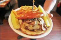  ??  ?? A burger from the new Arsenal City Tavern, located at 795Third Ave. in Watervliet.