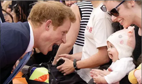  ??  ?? Hello littl’un: Harry greets a young well-wisher in Christchur­ch with a silly face – much to the child’s delight