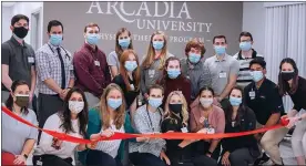  ?? SUBMITTED PHOTO ?? Arcadia University’s Department of Physical Therapy opened its student-run pro bono clinic on March 18to provide no-cost physical therapy to underinsur­ed or uninsured community members. This photos shows members of the department at the ribbon cutting for the clinic.