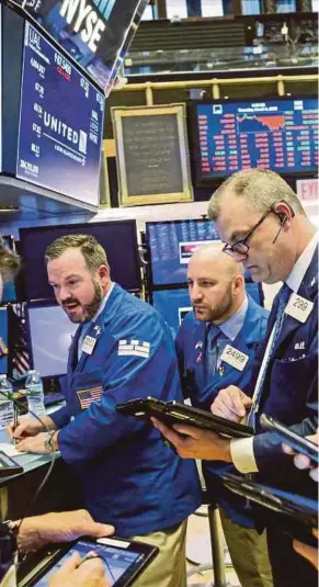  ?? AFP PIC ?? Traders at the New York Stock Exchange in New York City. United States President Donald Trump’s announceme­nt for new tariffs caused volatility in the markets last Friday.