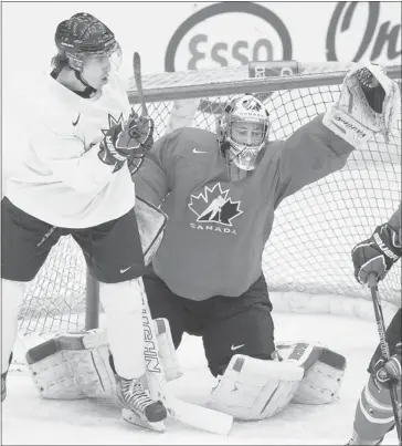  ?? Colleen De Neve/calgary Herald ?? Team Canada Junior team hopeful goalie Laurent Brossoit reached for the puck as CIS All-Stars Eric Galbraith of Mount Royal University (left) tried to screen him during their game at WinSport last Thursday.