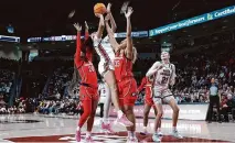  ?? Artie Walker Jr./associated Press ?? South Carolina’s Kamilla Cardoso scores two of her 16 points over Georgia’s Javyn Nicholson, right, and Jordan Cole.