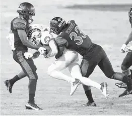  ?? MIGUEL VASCONCELL­OS ?? San Diego State’s Adonis Brown and Patrick Mcmorris stop Colorado State’s Thomas Pannunzio during Saturday’s game at Dignity Health Sports Park.