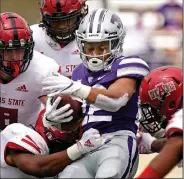  ?? (AP/Charlie Riedel) ?? Arkansas State’s defense, shown during the Red Wolves’ victory at Kansas State on Sept. 12, has struggled stopping opponents on third down since that game.