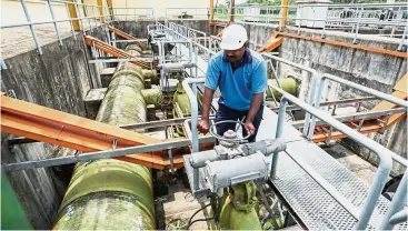  ??  ?? Water asset: A worker checking one of Splash’s water treatment plants. The Selangor state government has offered to buy the company, in which Gamuda is a shareholde­r, for RM2.55bil.