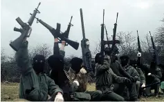  ??  ?? Armed response ...hooded IRA gunmen during a training exercise. Alleged informers were tortured, forced to confess and then murdered.