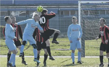  ?? ?? Hartlepool Raby Arms Over-40s (red/black) defend their goal against Seaton Buildings, last weekend.