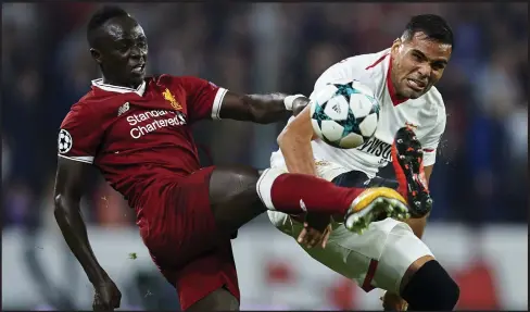  ??  ?? Sadio Mane, who scored Liverpool’s second goal in the first half, lays stray boot on Sevilla’s Gabriel Mercado at Estadio Ramon Sanchez Pizjuan