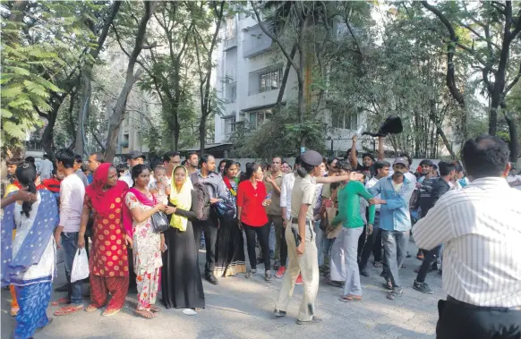  ?? Photos Subhash Sharma for The National; AFP ?? Police officers try to control the crowd outside Sridevi’s house in Mumbai yesterday. Sridevi’s stepdaught­er Anshula Kapoor, left, goes to Boney Kapoor’s house in Mumbai. An ambulance, far left, takes the actress’s body home