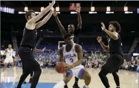  ??  ?? UCLA forward Cody Riley (2) is surrounded by Colorado defenders during the second half of an NCAA college basketball game on Wednesday, in Los Angeles. AP PHOTO/MARCIO JOSE SANCHEZ