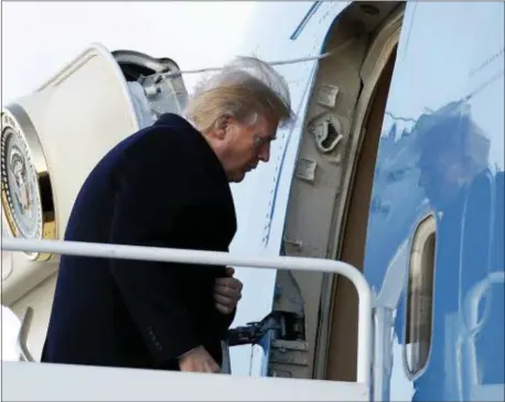  ?? CAROLYN KASTER — THE ASSOCIATED PRESS ?? President Donald Trump boards Air Force One, Friday in Andrews Air Force Base, Md., en route to Palm Beach Internatio­nal Airport, in West Palm Beach, Fla.