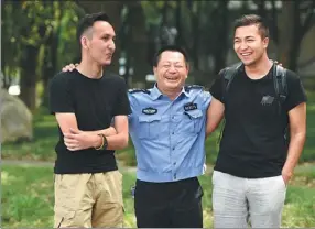  ?? PROVIDED TO CHINA DAILY ?? Xia Qingliang shares a joke with two Uygur students from the Xinjiang Uygur autonomous region on the campus of the South-Central University for Nationalit­ies in Wuhan.