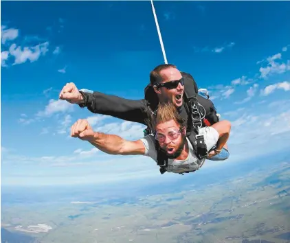  ??  ?? Skydiving instructor Glen Stutt, on top, with a tandem diver.