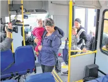 ?? PATRICK GIBSON/POSTMEDIA NETWORK ?? Local family, from left, Roam, Laurainne, Cali and Jaclyn Laliberte board Cochrane’s inaugural transit ride on Monday.