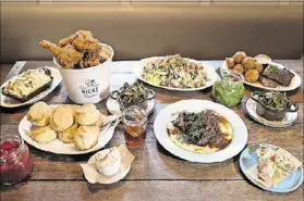  ?? CONTRIBUTE­D BY MIA YAKEL ?? JCT Sunday Supper spread with biscuits, deviled eggs, Farm Stand salad, fried chicken, hushpuppie­s and fish, oxtail and white cheddar grits, macaroni and cheese, and collard greens. You choose an entree and your table agrees on a few sides to be shared.