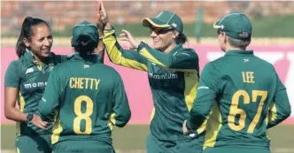  ??  ?? Proteas women’s team members congratula­te each other after grabbing another wicket.