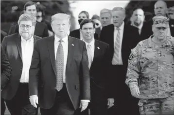  ?? BRENDAN SMIALOWSKI/GETTY-AFP ?? Mark Milley, right, chairman of the Joint Chiefs of Staff, walks with President Donald Trump to Lafayette Square on June 1.