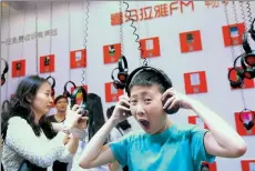  ?? PROVIDED TO CHINA DAILY ?? A boy listens to an audio program presented by Ximalaya at a fair featuring audio books and user-generated content in Shanghai.