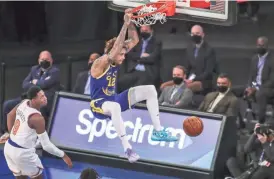  ?? WENDELL CRUZ/POOL PHOTO VIA AP ?? Warriors guard Kelly Oubre Jr. (12) dunks against the Knicks during the third quarter Tuesday in New York.