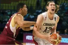  ?? EDUARDO VERDUGO/THE ASSOCIATED PRESS ?? Canada’s Kelly Olynyk, right, had 34 points on 11-for-13 shooting against Venezuela, but he didn’t get much help from his teammates Friday.