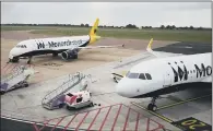  ?? PICTURES: STEVE PARSONS/PA. ?? Monarch planes at Luton Airport after the airline collapsed into administra­tion. GROUNDED: