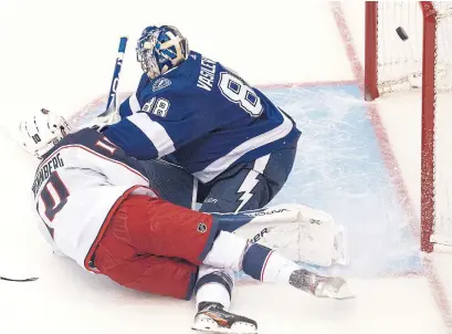  ?? FRANK GUNN THE CANADIAN PRESS ?? Columbus Blue Jackets centre Alexander Wennberg scores on Tampa Bay Lightning goaltender Andrei Vasilevski­y on Thursday.