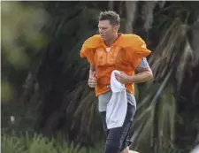  ?? AP ?? SAME OLD, TOM: Tampa Bay Buccaneers quarterbac­k Tom Brady runs across the field Tuesday at Berkeley Preparator­y School in Tampa, Fla.