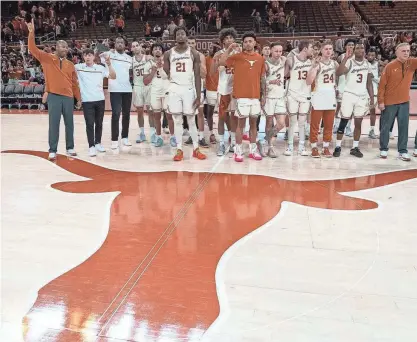  ?? MIKALA COMPTON/AMERICAN-STATESMAN ?? Texas players stand for “The Eyes of Texas” following Wednesday night's 77-71 loss to Central Florida at Moody Center. It dropped the Longhorns to 1-3 in the Big 12 standings.