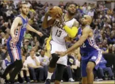  ?? MICHAEL CONROY — THE ASSOCIATED PRESS ?? Indiana forward Paul George (13) looks to pass in front of 76ers guards Nik Stauskas (11) and Gerald Henderson (12) during the second half of Sunday’s game in Indianapol­is. The Pacers won, 107-94.
