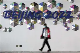 ?? DAVID J. PHILLIP / ASSOCIATED PRESS ?? A person walks past a Beijing 2022 sign inside the main media center at the 2022 Winter Olympics on Saturday in Beijing.
