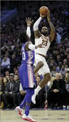  ?? MATT SLOCUM — THE ASSOCIATED PRESS ?? Cleveland’s LeBron James, right, goes up for a shot against Philadelph­ia’s Robert Covington Monday.