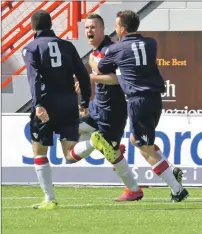  ??  ?? Brian Mackay and Donald Campbell congratula­te Paul Carmichael on his goal.