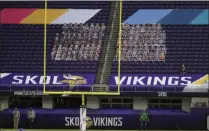  ?? BRUCE KLUCKHOHN ?? Cutouts of Minnesota Vikings fans are shown in the stands of US Bank Stadiumdur­ing the second half of an NFL football game between the Atlanta Falcons and Minnesota Vikings in Minneapoli­s, in this Sunday, Oct. 18, 2020, file photo. The eight teams hosting NFL playoff games thismonth aremore than happy to be staying home with all of comfort it brings, but the actual advantage of playing . there all but disappeare­d during this pandemic season of mostly empty stadiums.
