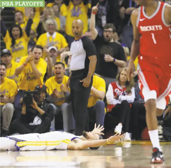  ?? Scott Strazzante / The Chronicle ?? Warriors guard Stephen Curry celebrated from the floor after driving across the lane to make a layup midway through the third quarter against the Rockets.