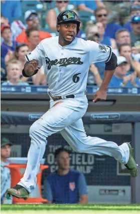  ?? CHRIS KOHLEY / MILWAUKEE JOURNAL SENTINEL ?? Lorenzo Cain scampers home on a triple by Christian Yelich in the fourth inning.