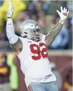  ?? KYLE ROBERTSON/COLUMBUS DISPATCH ?? Ohio State defensive tackle Haskell Garrett (92) scores a touchdown after picking up a fumble against Minnesota during the third quarter Thursday night.