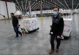  ?? PAUL SANCYA — THE ASSOCIATED PRESS ?? Boxes containing the Moderna COVID-19 vaccine are moved for shipping in Olive Branch, Miss., on Sunday.