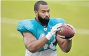  ?? MARIA LORENZINO/STAFF FILE PHOTO ?? Linebacker Spencer Paysinger catches a ball during drills at Dolphins training camp last summer.
individual