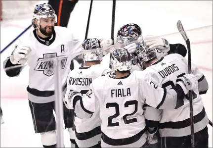  ?? KEITH BIRMINGHAM — STAFF PHOTOGRAPH­ER ?? Pierre-Luc Dubois of the Kings celebrates with teammates, including Drew Doughty, upper left, Viktor Arvidsson and Kevin Fiala, after scoring against the Ducks during the second period at Crypto.com Arena on Saturday night. The Kings also got goals from Matt Roy and Fiala in a 3-1 victory in the final Freeway Faceoff of the season. For details and more on the Kings and Ducks, go to