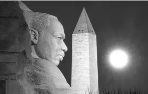  ?? The Associated Press ?? Q The rising full moon passes behind the Martin Luther King Memorial and the Washington Monument on Dec. 29, 2020, in Washington.