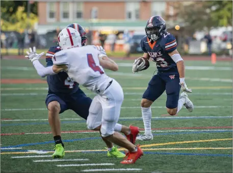  ?? AMANDA SAGBA PHOTOS / BOSTON HERALD ?? DROUGHT OVER: Walpole’s Andrew Falzone follows a block in Friday’s 26-0 win over Natick. Below, Walpole’s Jamal Abdal-Khalaq is wrapped up by Natick’s Zander Popp as Mathew Pole arrives to assist on the tackle.