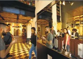  ?? Genaro Molina Los Angeles Times ?? THE HOSPITALIT­Y industry discovered the magic of fees around 1997. Above, visitors walk through the reception area of the Ace Hotel in Los Angeles in 2014.