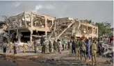  ?? — AP ?? Officials search for bodies in Mogadishu on Sunday at the scene of Saturday’s truck bomb blast.