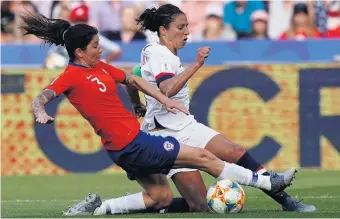  ?? LIONEL BONAVENTUR­E/AFP/GETTY IMAGES ?? Chile defender Carla Guerrero, left, battles for possession with United States forward Carli Lloyd during the teams’ World Cup match Sunday. The U.S. won 3-0 and will face Sweden in the Group F finale Thursday.